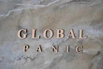 GLOBAL PANIC , writen wooden letters on stone background