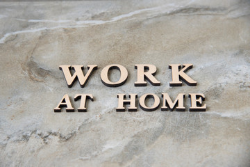 WORK AT HOME , writen wooden letters on stone background