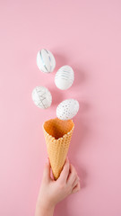 White easter eggs with silver pattern on pink
