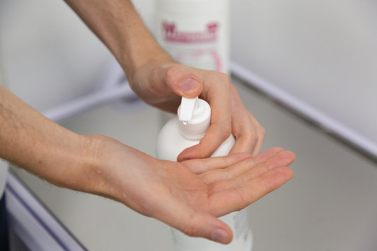 The doctor disinfects the hands. The doctor washes his hands with soap and treats with an antiseptic