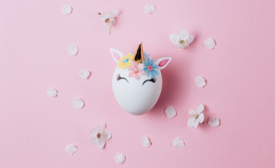 Easter eggs in the form of a unicorn on pink background. Happy Easter time. Creative Easter decoration. Copy space. Flat lay