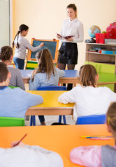 Schoolgirl at whiteboard with teacher