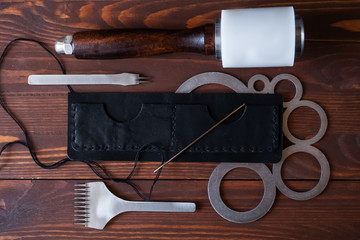 Genuine Leather. Sewing a purse. Leather work. Tools for sewing bags, wallets, clutches. Stitching....