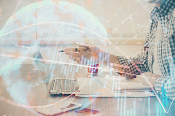 Multi exposure of stock market chart with man working on computer on background. Concept of financial analysis.