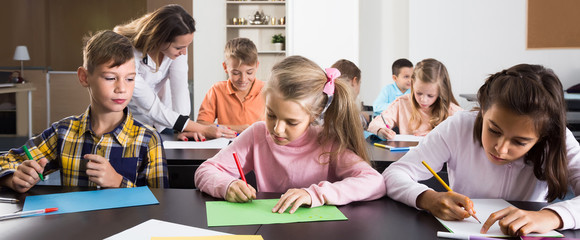 Children of elementary age having class of art