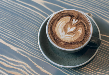 A glass of coffee with milk foam