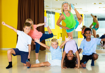Positive children in dance studio smiling and having fun