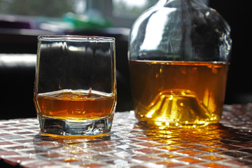 Glass of scotch whiskey on dark background