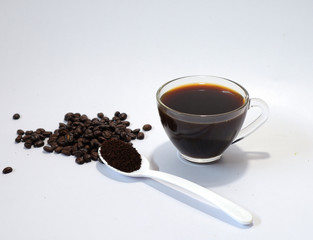 coffee beans, ground coffee, black coffee in a glasson a white background