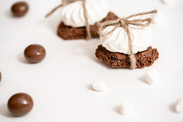 Chocolate Day July 7th.Sweets on white background, a steak of white and black chocolate. concept of choice. White marshmallows or dark bitter chocolate.The inscription on the card