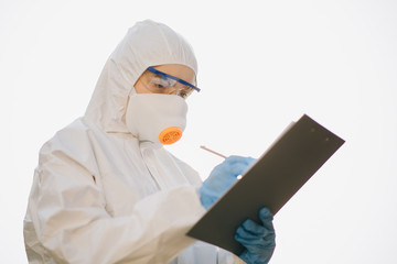 Successful chemist in a suit posing on a white background isolated. Worker in chemical protective...