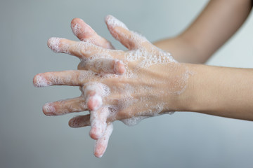 Washing hands with foamy soap, protection against coronavirus. Close up