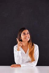 Woman pointing to a blackboard