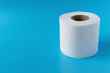 Roll of toilet paper on a blue background. Personal hygiene item for the bathroom