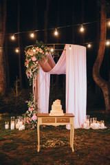 white wedding cake decorated with pink flowers