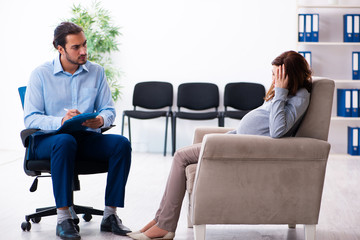 Pregnant woman visiting young male psychologist