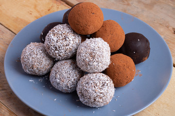 Homemade raw chocolate energy balls with nuts and seeds and coconut flakes