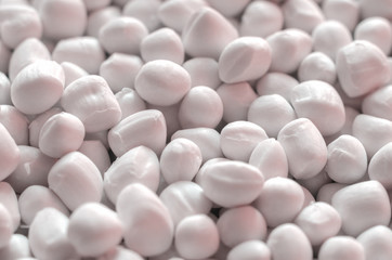 Fototapeta na wymiar White polymer dye in granules, background texture