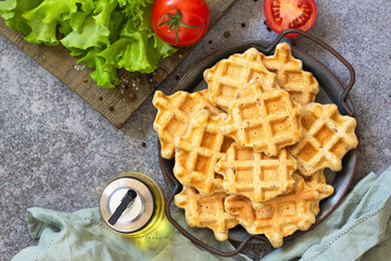 Fish wafers with canned tuna, a quick snack in a plate on a gray stone or concrete countertop. Top view flat lay background. Copy space.