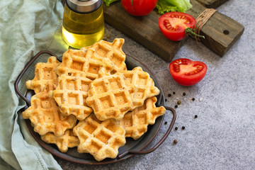 Fish wafers with canned tuna, a quick snack in a plate on a gray stone or concrete countertop. Copy space.