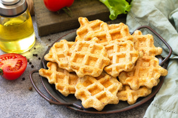 Fish wafers with canned tuna, a quick snack in a plate on a gray stone or concrete countertop.
