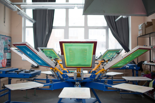 Silk screen printing. Serigraphy. Color paints and fabric. Carousel machine.