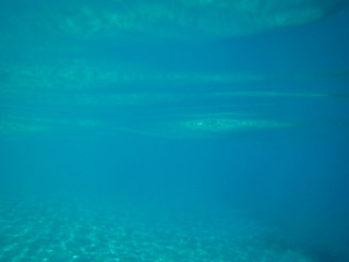 Fototapeta na wymiar Sandy sea floor with reflections of sunlight .