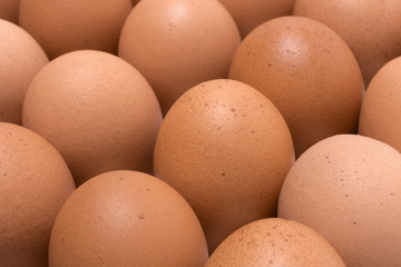 Raw chicken eggs in carton box on wooden table,Eggs background.