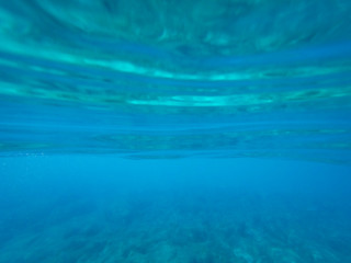 Rocky sea floor with reflections of sunlight .
