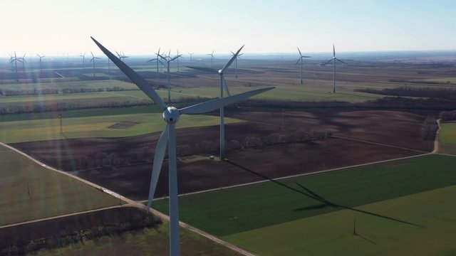 a close up view of a wind turbine on austria hungarian border on A4 autobahn a part of E60 road with a lot of other wind turbnes on backgorund
