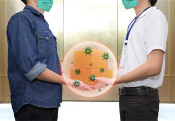Man wear healthy face mask when accepting delivery boxes from delivery man.  The corona virus (Covid-19) comes from package cover.