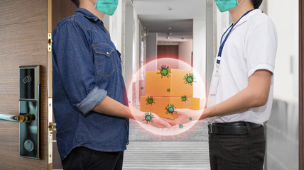Man wear healthy face mask when accepting delivery boxes from delivery man.  The corona virus (Covid-19) comes from package cover.