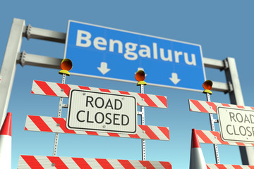 Road barricades near Bengaluru city road sign. Coronavirus disease quarantine or lockdown in India conceptual 3D rendering