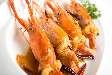 fired giant freshwater prawn with tamarine sauce on with plate closeup shot