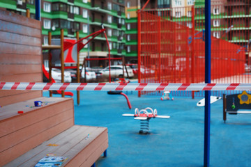 Fototapeta na wymiar Fenced children's playground during coronavirus or covid 19 quarantine.