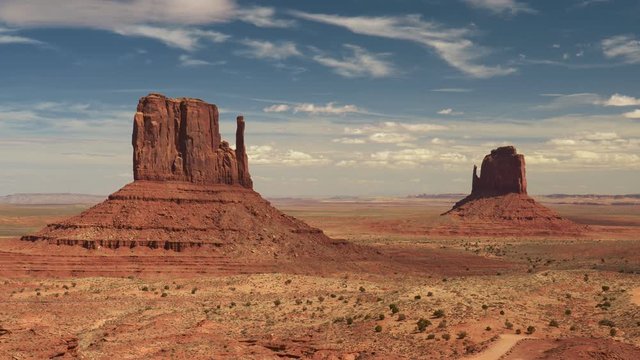 Panning shot of Monument Valley, Arizona, USA. Fancy rock formations under blue sky in Monument Valley, UHD, 4K