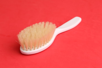 white hairbrush in color background