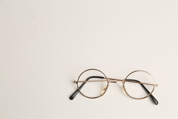 glasses with round crystals on colored background