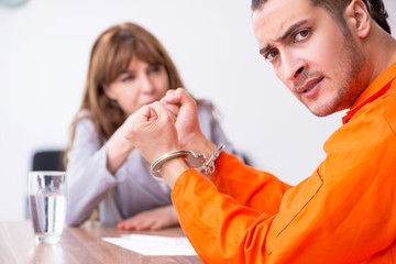 Young man meeting with advocate in pre-trial detention