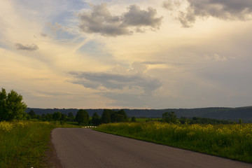 Road outside the city at sunset