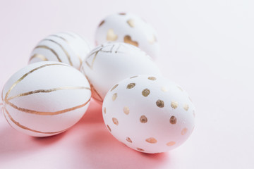 Easter eggs are hand-drawn on pink pastel background. Selective focus. Space for text. Minimalism and Happy Easter concept.