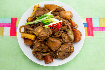Korean chicken stew with soy sauce, glass noodle, rice cake and vegetables
