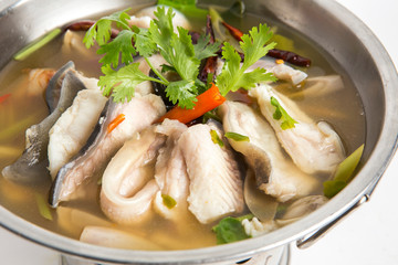 tom yum blanched sea bass fish in hot pot closeup shot