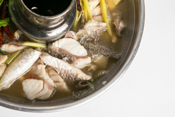 blanched sea bass fish tom yum soup in hot pot closeup shot look delicious