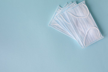 Medical concept on a blue background. Means of protection against the virus: medical mask. Place...
