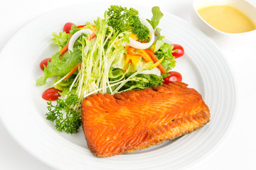 grilled salmon salad serve with mixed clear noodle coriander decorate by parsley and chili serve in white plate isolated white background