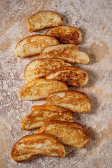 Fried croutons or egg toasts in a stone beige background. Stack of French toasts for breakfast. Cook book or menu concept