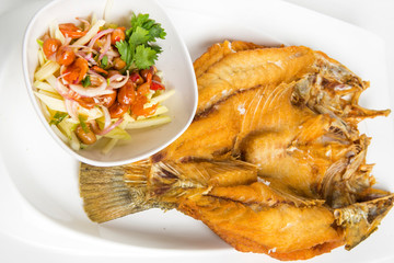 deep fried sea bass with fish sauce eat with thai spicy and sour mango peanuts sauce