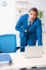 Young male employee in work accident concept