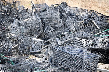 Close up background image of pile of used black plastic baskets from the market in nature. Concept of environment and plastic waste. Georgia. 2020